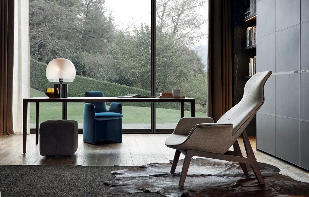 A living room with a couch,  Poliform Armchairs and table
