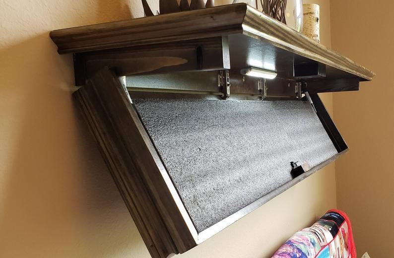 A kitchen stove top oven sitting on top of a wooden shelf
