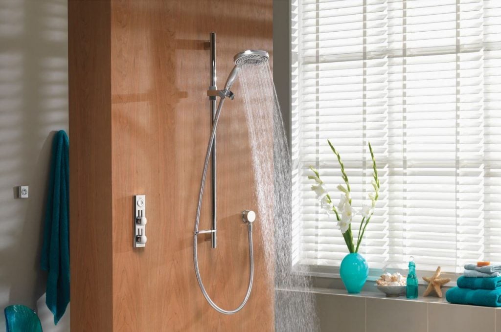 A bathroom with a shower head and hand shower
