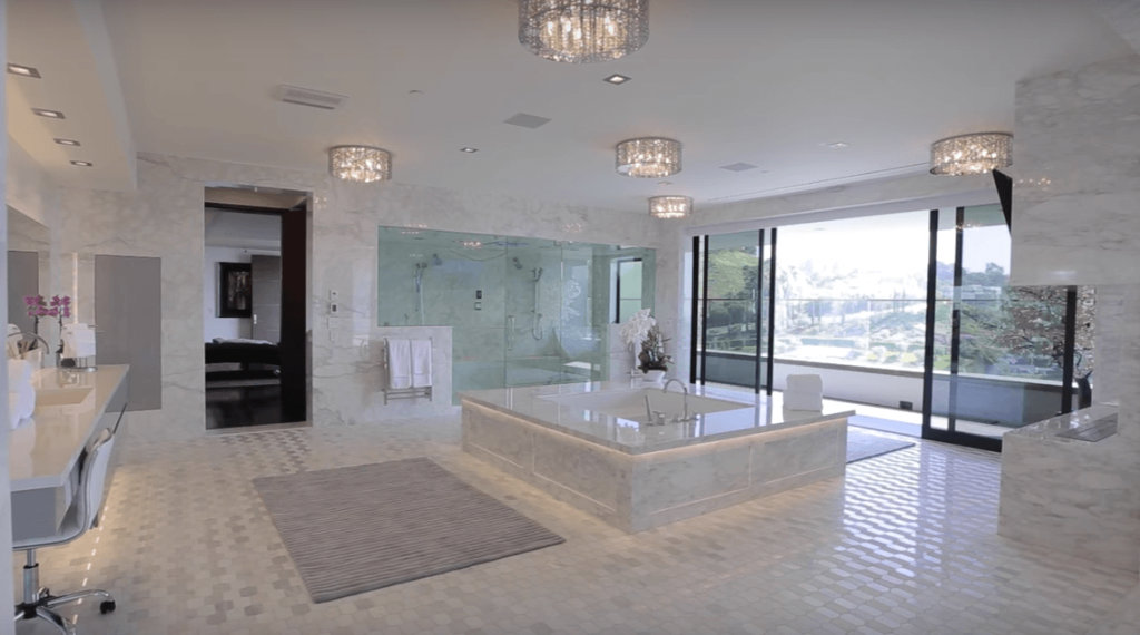 A large bathroom with a tub and a sink
