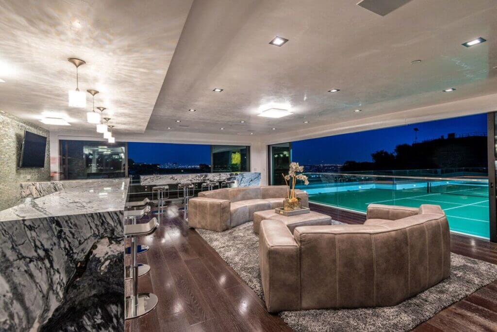 A living room filled with furniture next to a swimming pool
