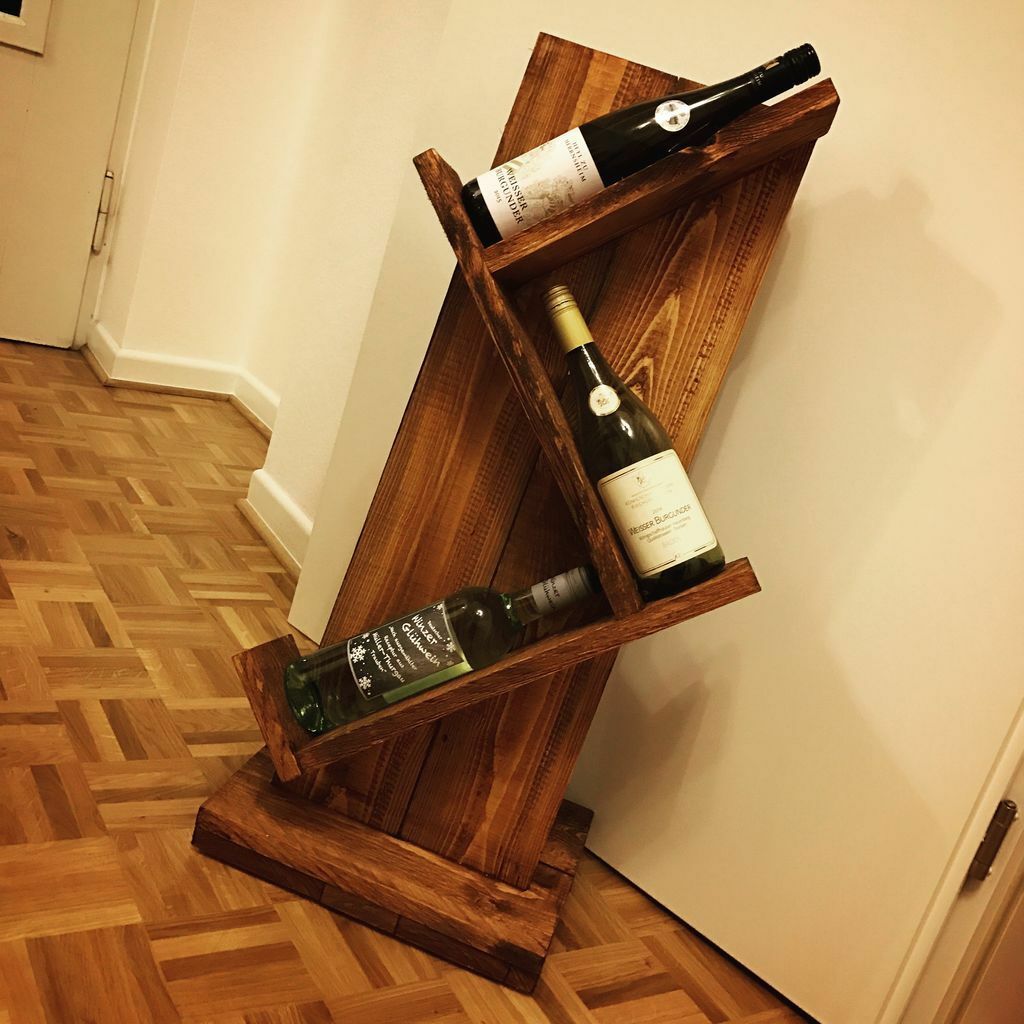 A wooden wine rack holding two bottles of wine
