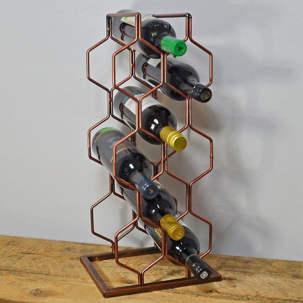 A metal wine rack holding several bottles of wine
