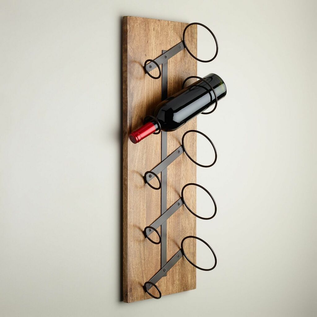 A wooden wine rack with two wine bottles on it
