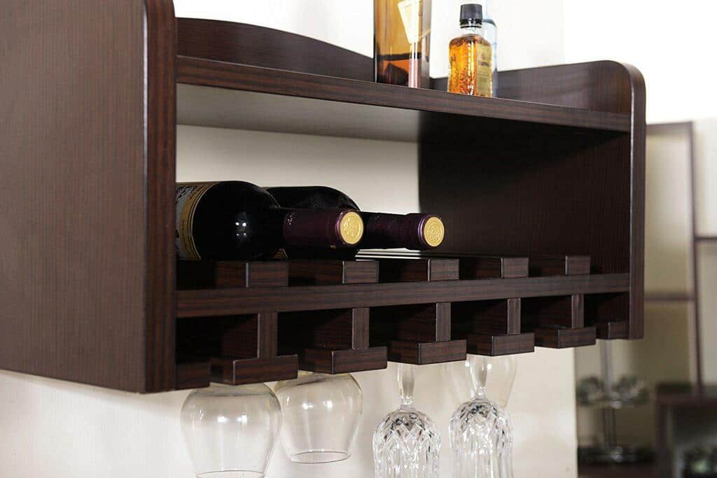 A shelf with wine glasses and bottles on it
