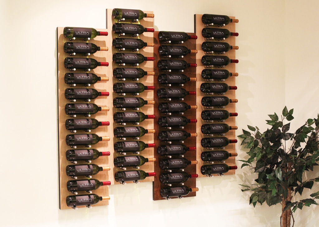 A bunch of wine bottles that are on a wall
