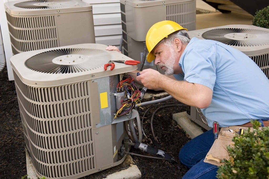 A man working on an air conditioner
