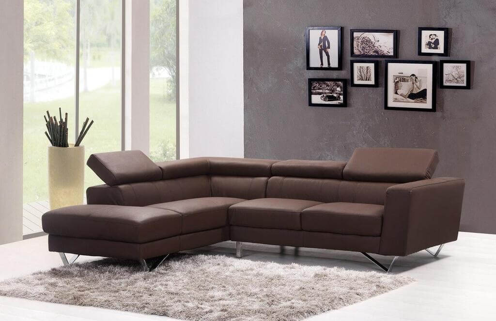 A living room with a sectional sofa and a rug
