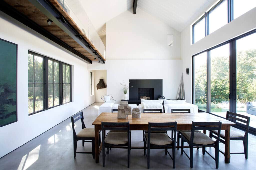 A dining room table with chairs and a fire place
