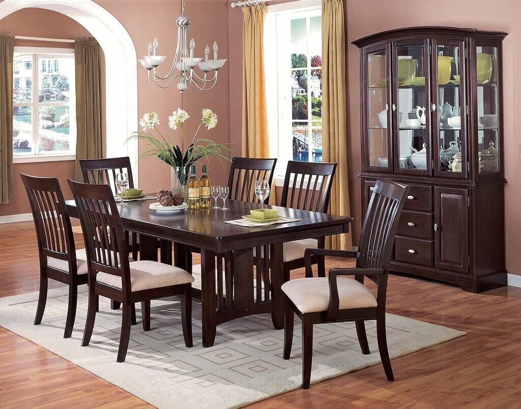 A dining room table with chairs and a china cabinet
