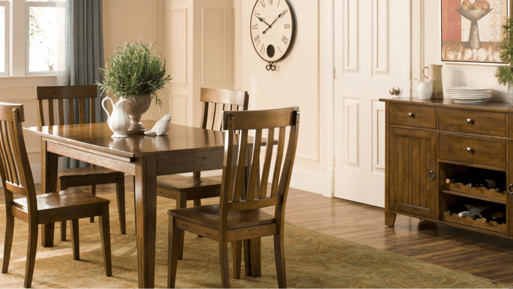 A dining room table and chairs with a clock on the wall
