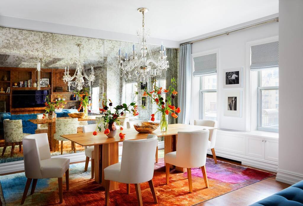 A dining room table with chairs and a chandelier
