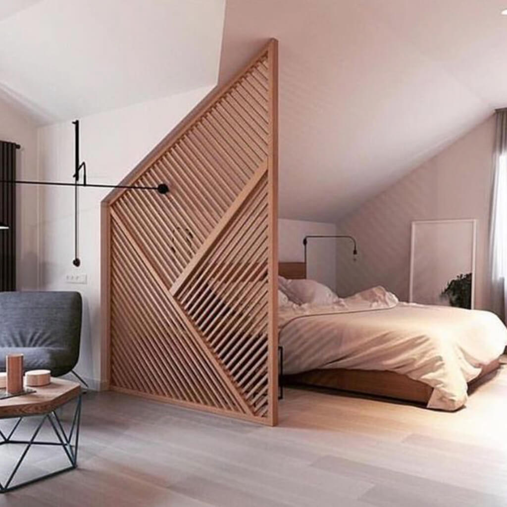 A bedroom with a bed and a chair in it

