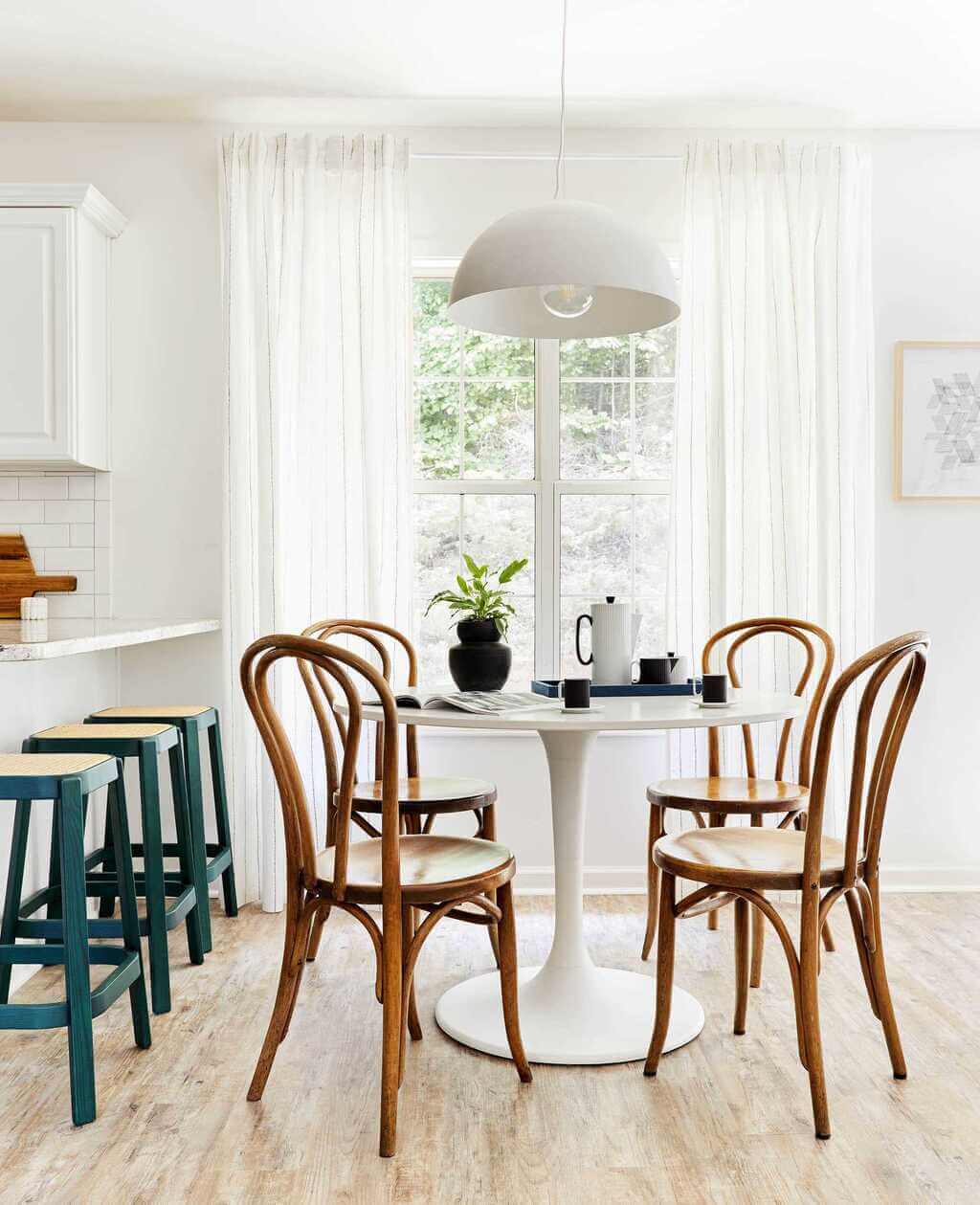 A white table with four chairs around it
