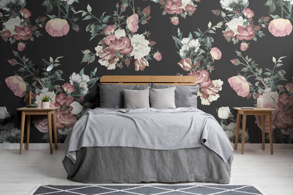 A bedroom with floral wallpaper and a bed
