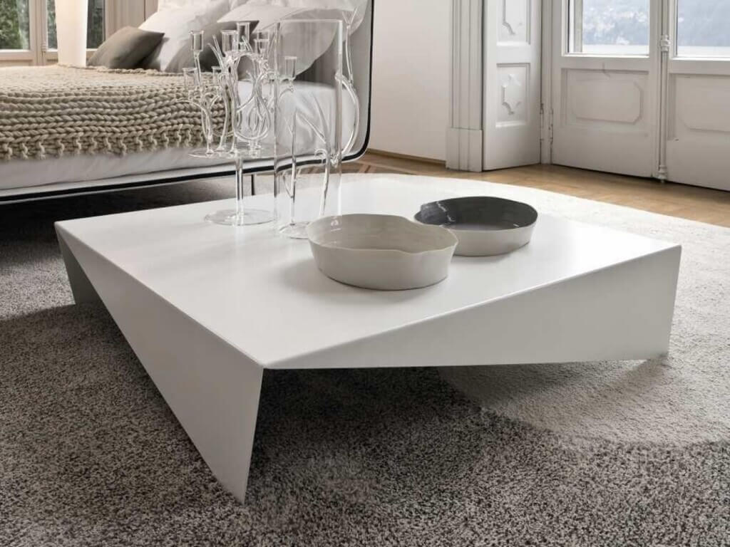 A white coffee table sitting on top of a carpeted floor
