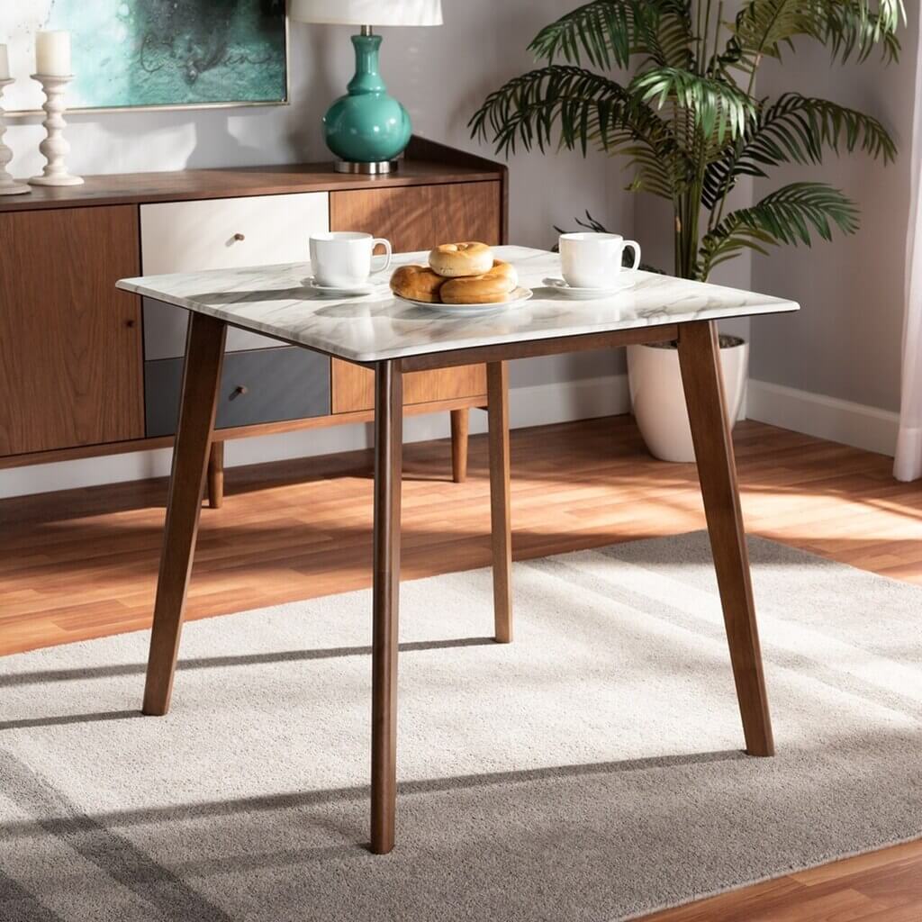 A table with two cups of coffee and pastries on it
