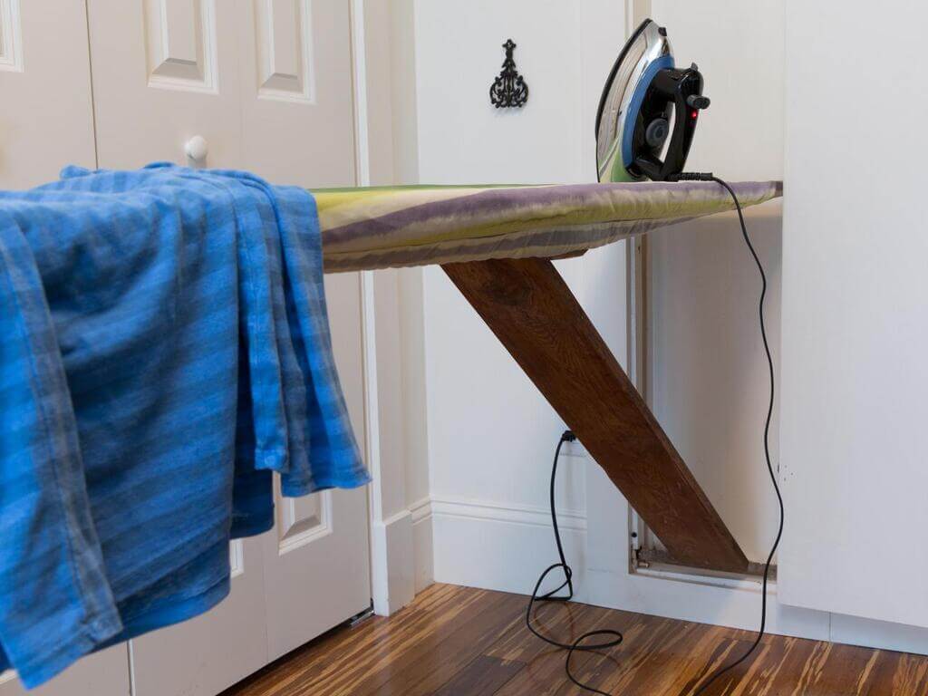 old hidden ironing board in kitchen wall