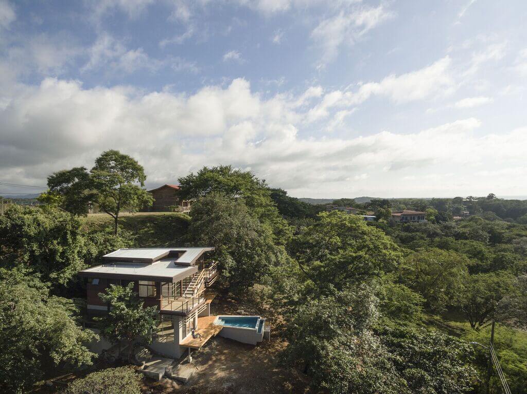An aerial view of a house surrounded by trees
