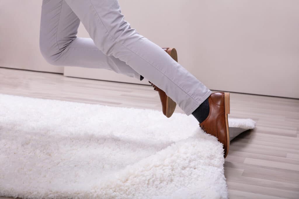 Check for Loose Rugs, Cords, and Furniture Before You Walk Over Them to Prevent Falls