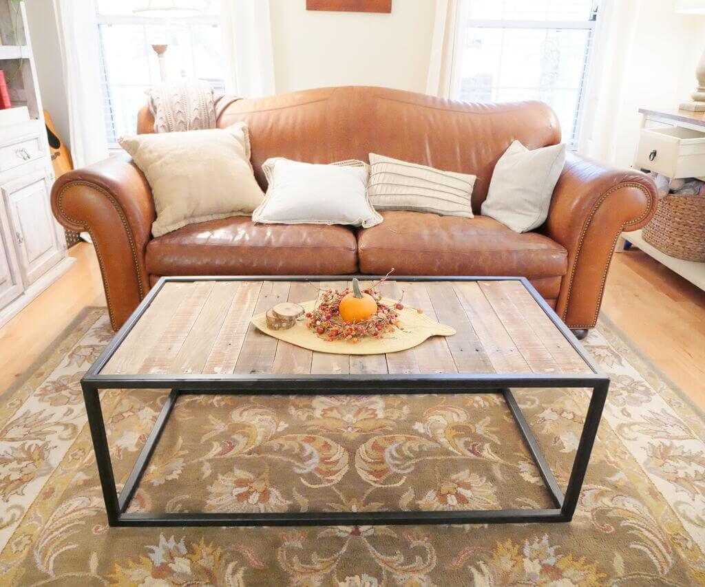 A living room with a leather couch and a coffee table
