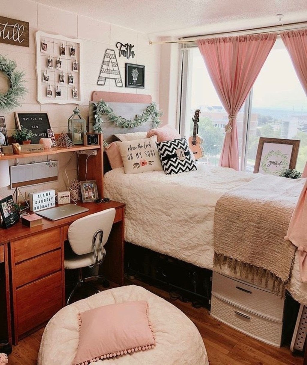 A bedroom with a bed, desk, chair and window
