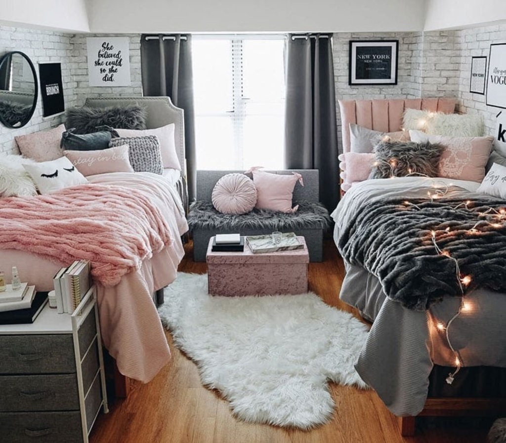 A bedroom with two beds, a couch and a window
