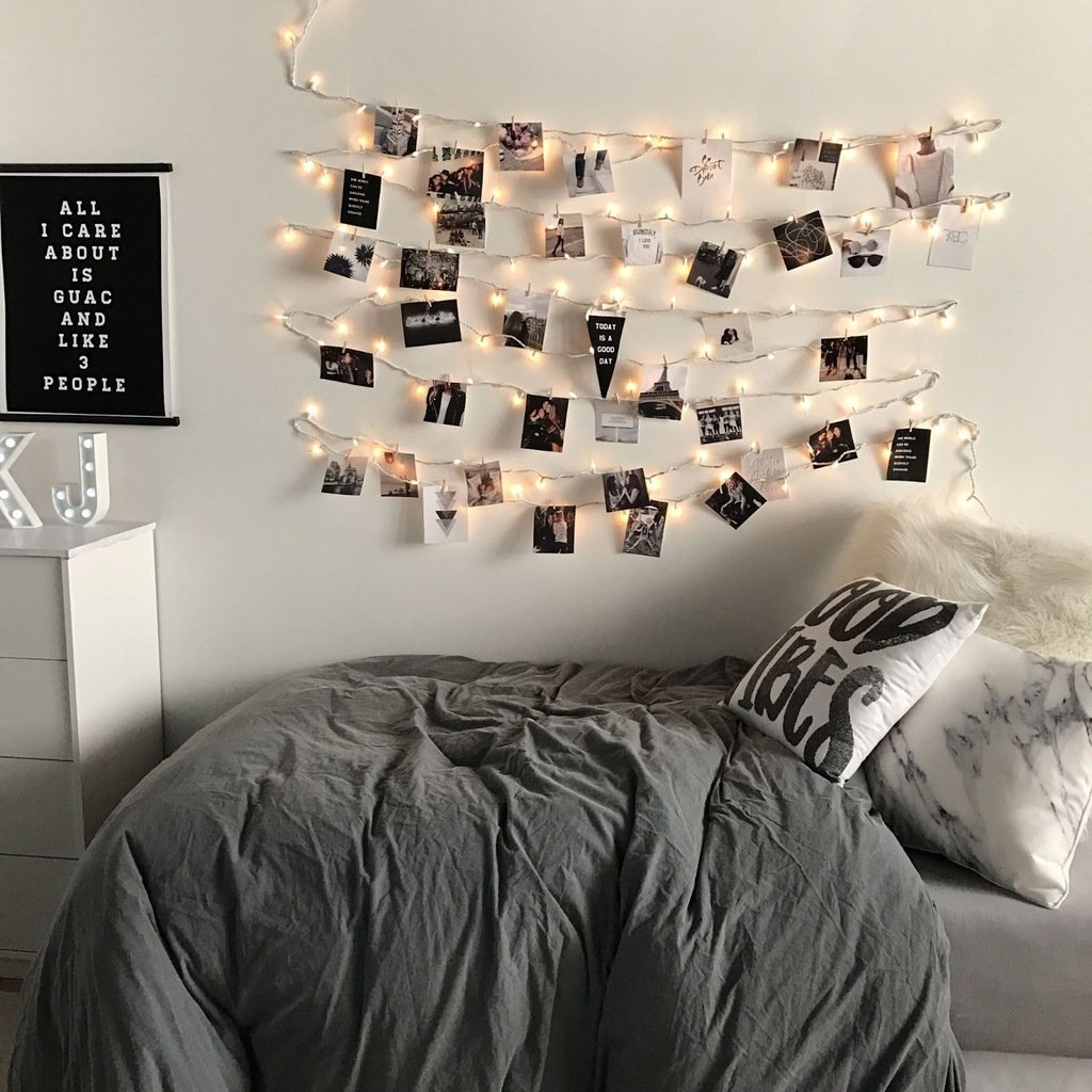 A bedroom with a bed and a string of lights
