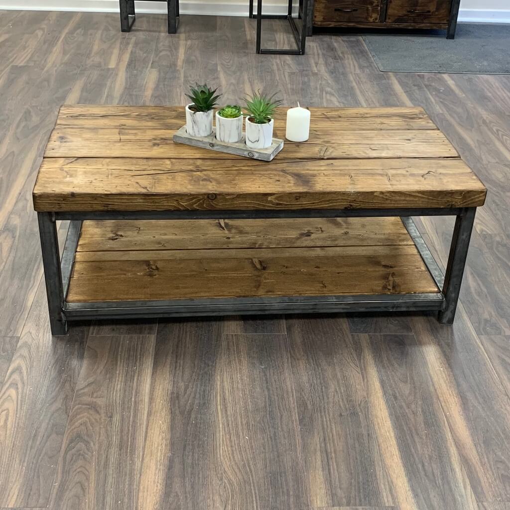 A coffee table with two planters on top of it
