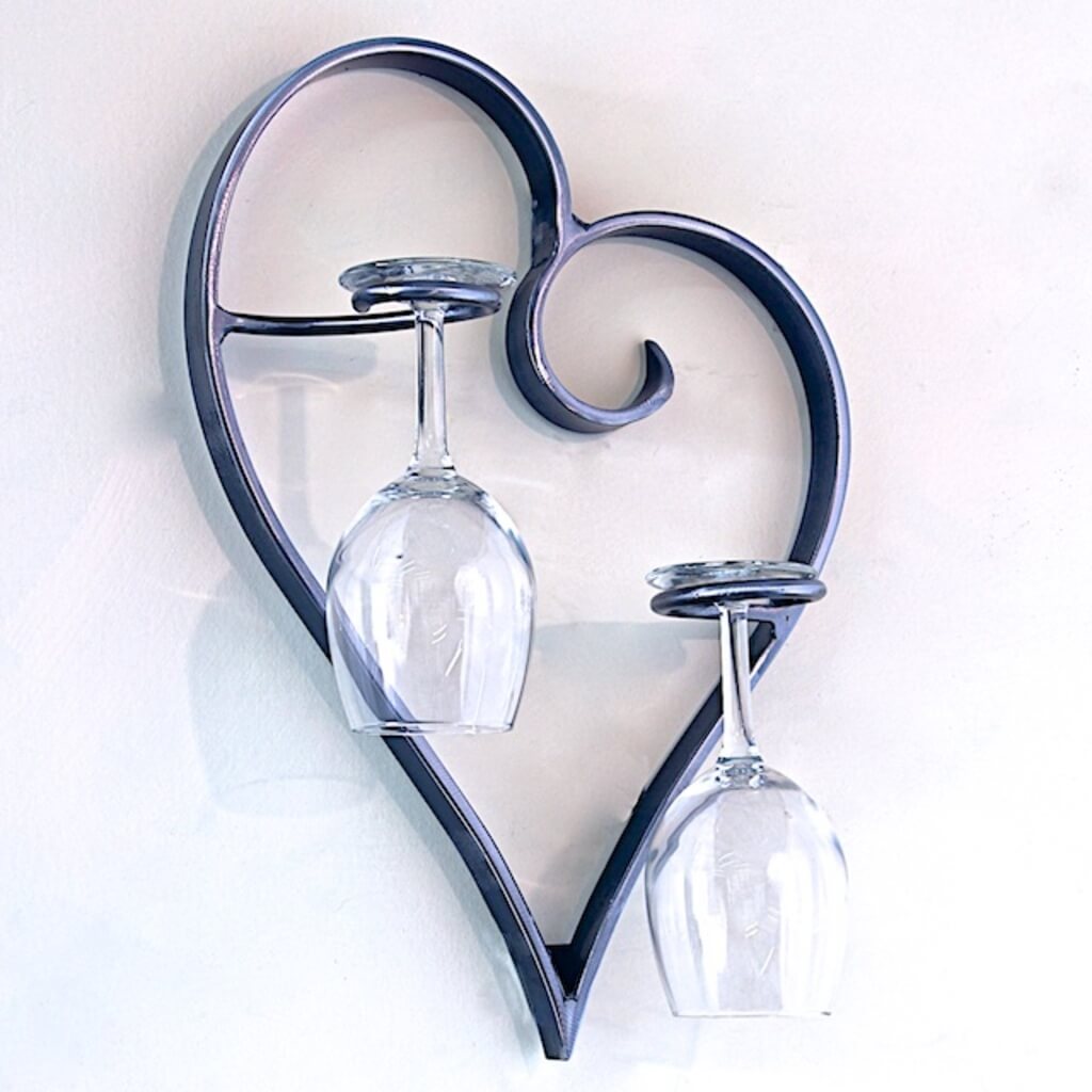 A metal heart shaped wine glass holder
