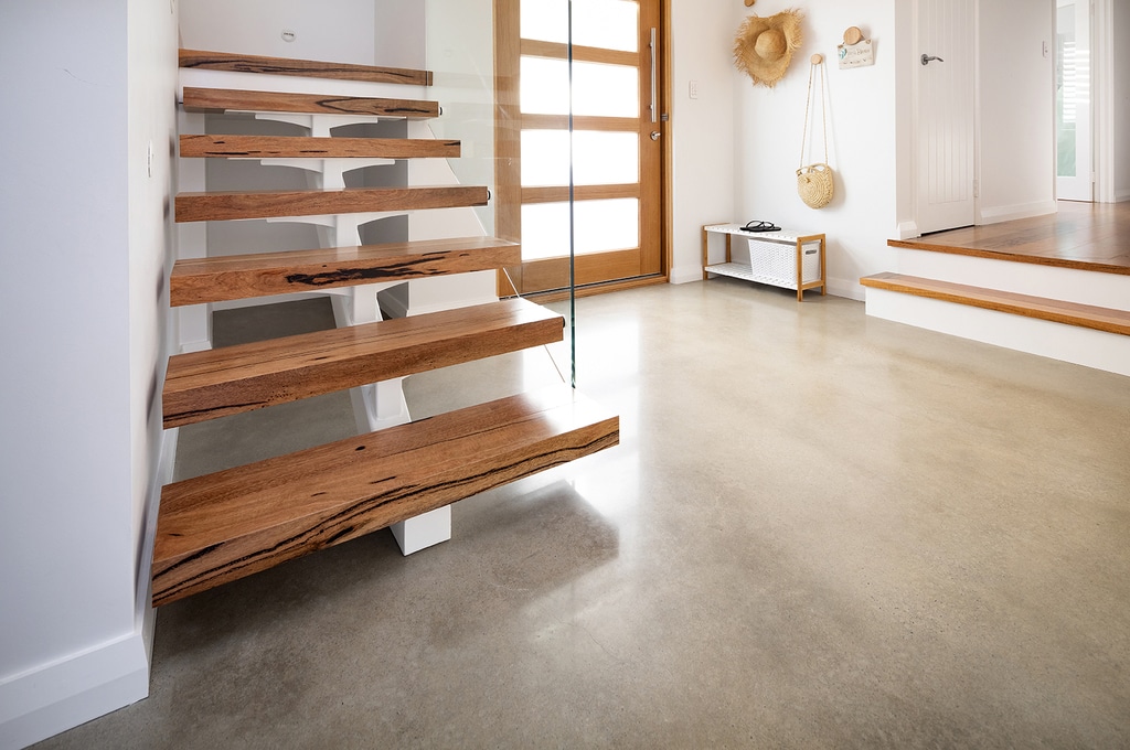 A wooden stair case next to a wooden door
