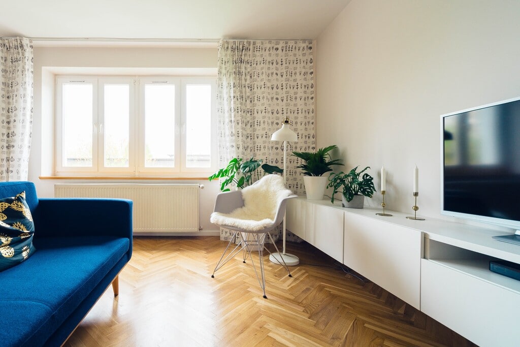 A living room with a blue couch and a flat screen tv
