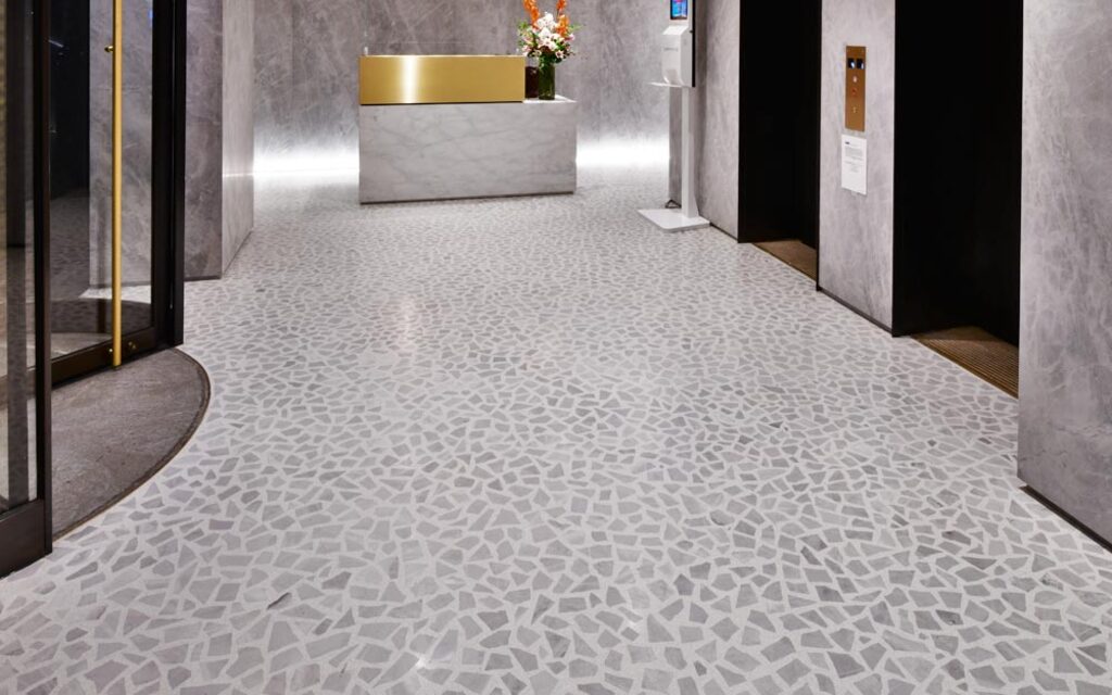 A long hallway with a white and gold counter

