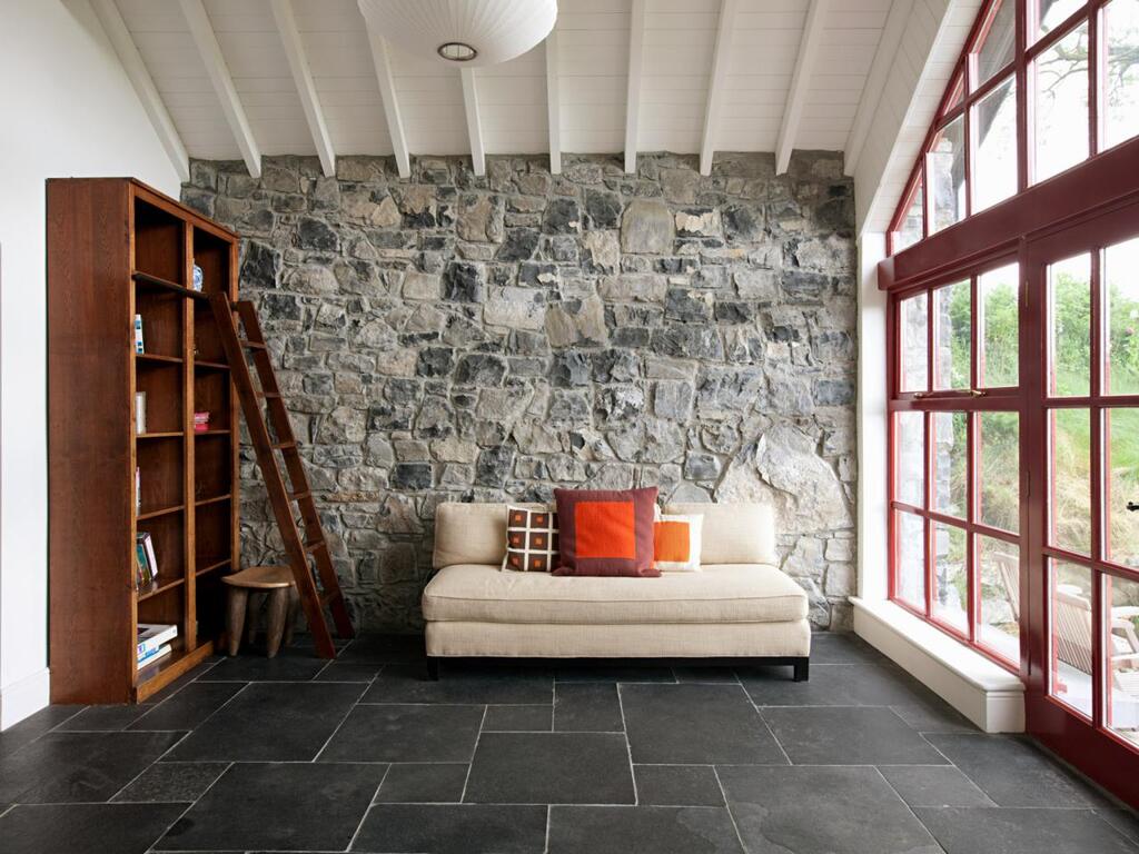 A living room with a couch and a book shelf
