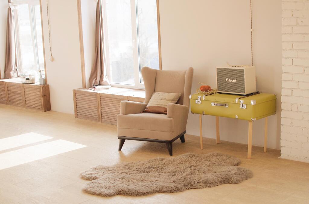 A living room with a yellow chair and a yellow table
