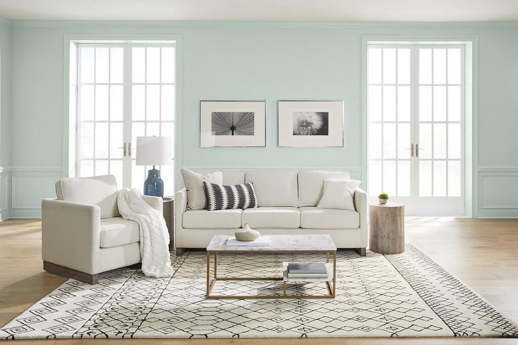 A living room with blue walls and white furniture
