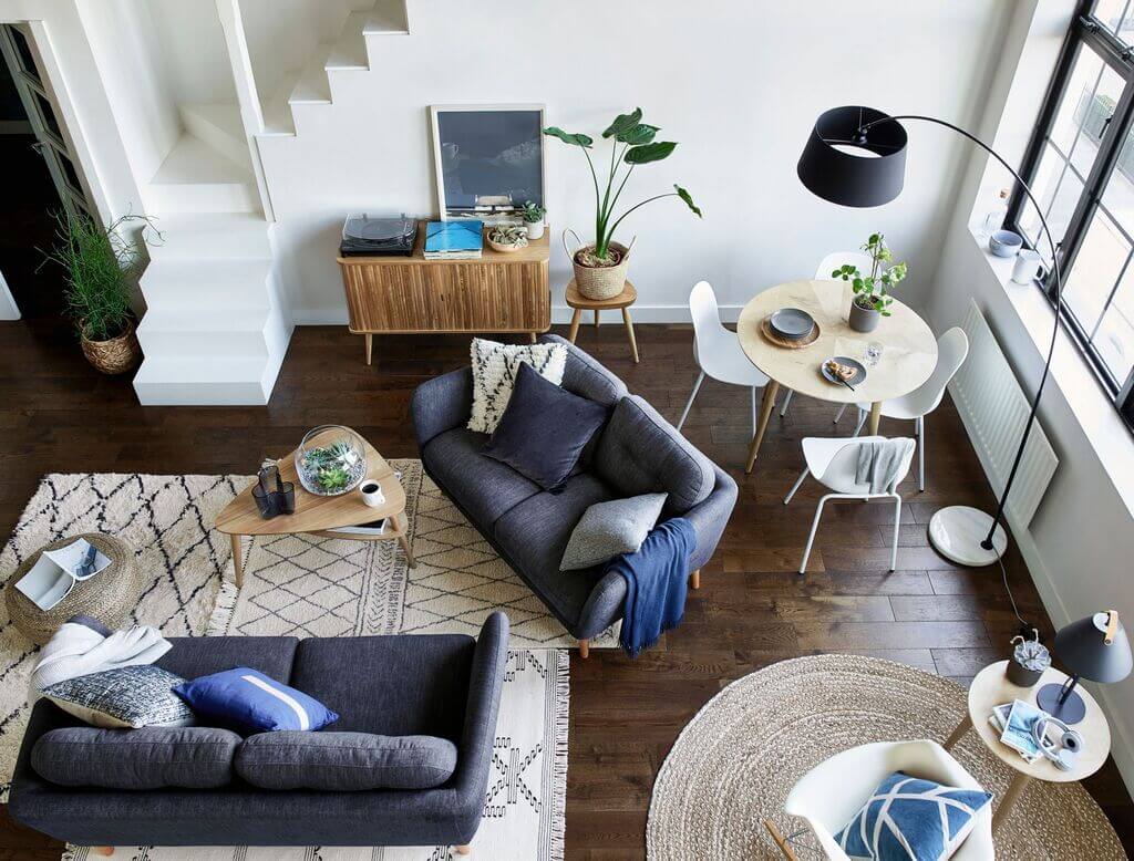 A living room filled with furniture and a staircase
