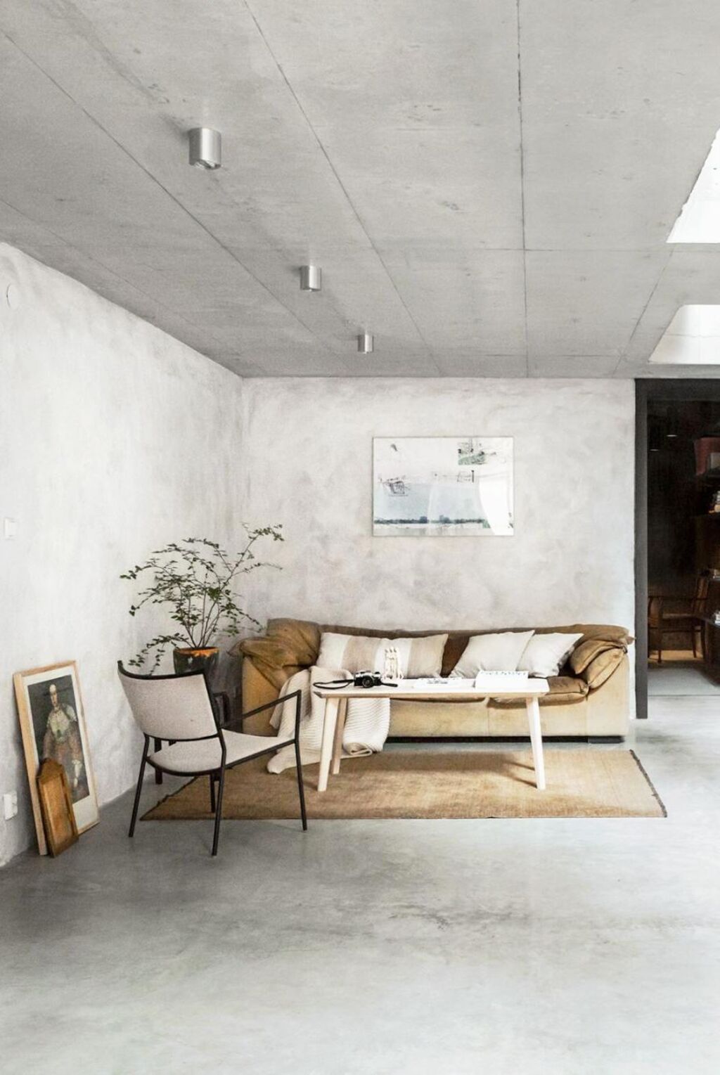 A living room filled with furniture and a white wall
