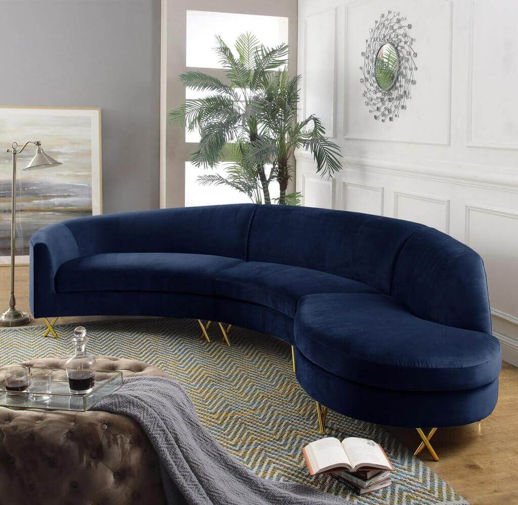 A blue couch sitting on top of a rug in a living room
