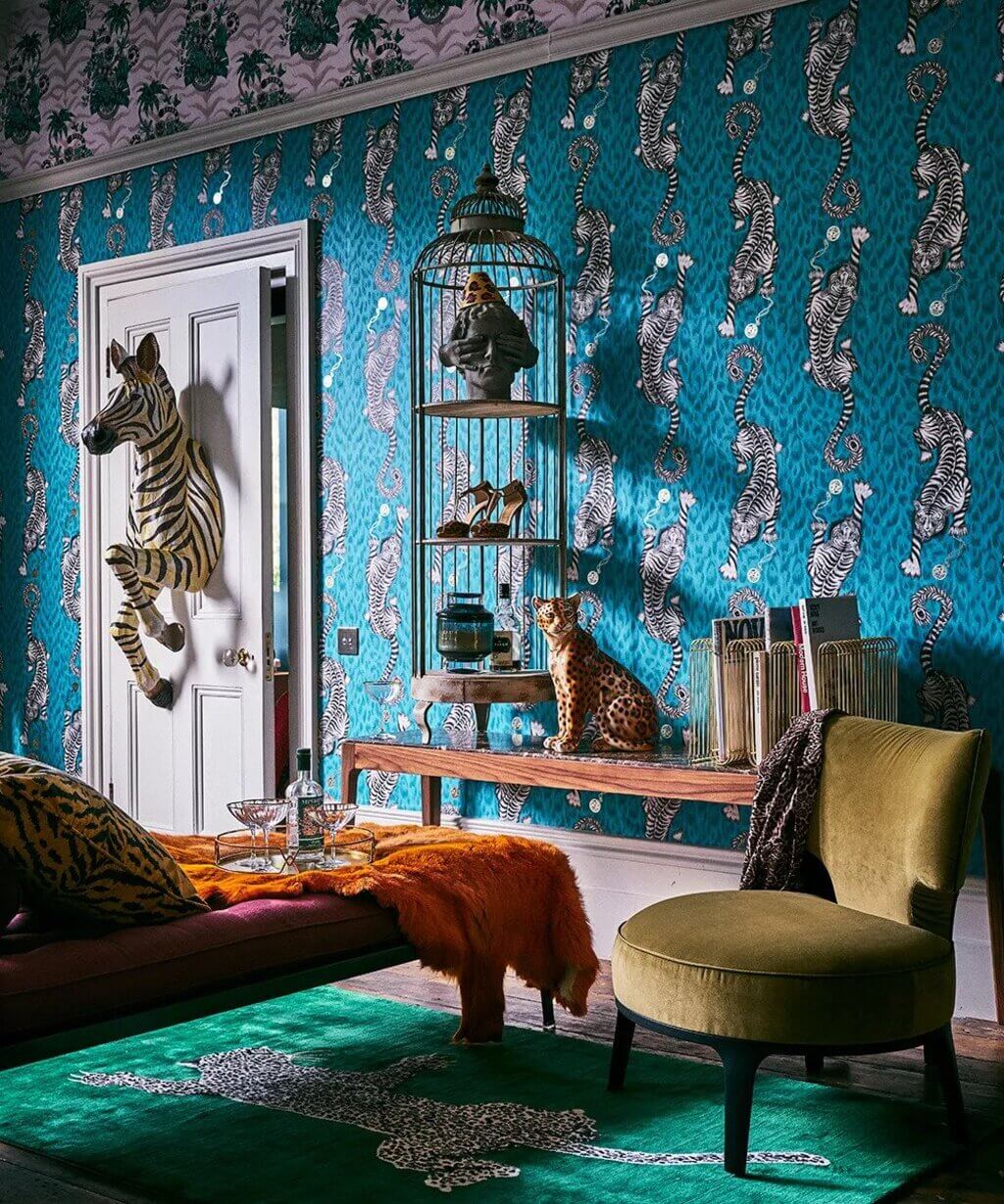 A living room with a zebra print wallpaper and a birdcage
