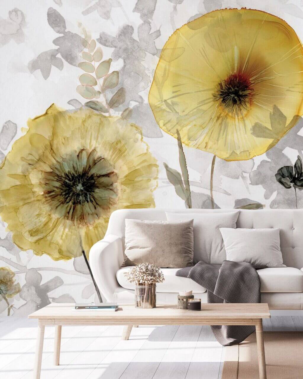 A living room with a white couch and yellow flowers on the wall
