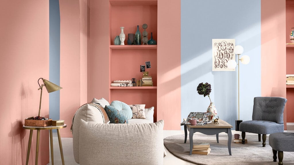 A living room with pink and blue walls
