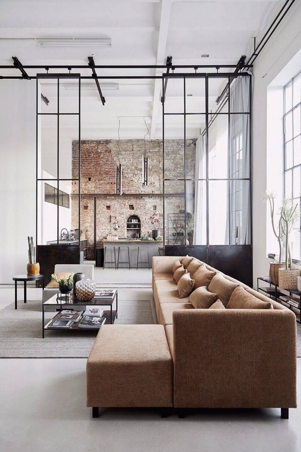 A living room filled with furniture and a brick wall
