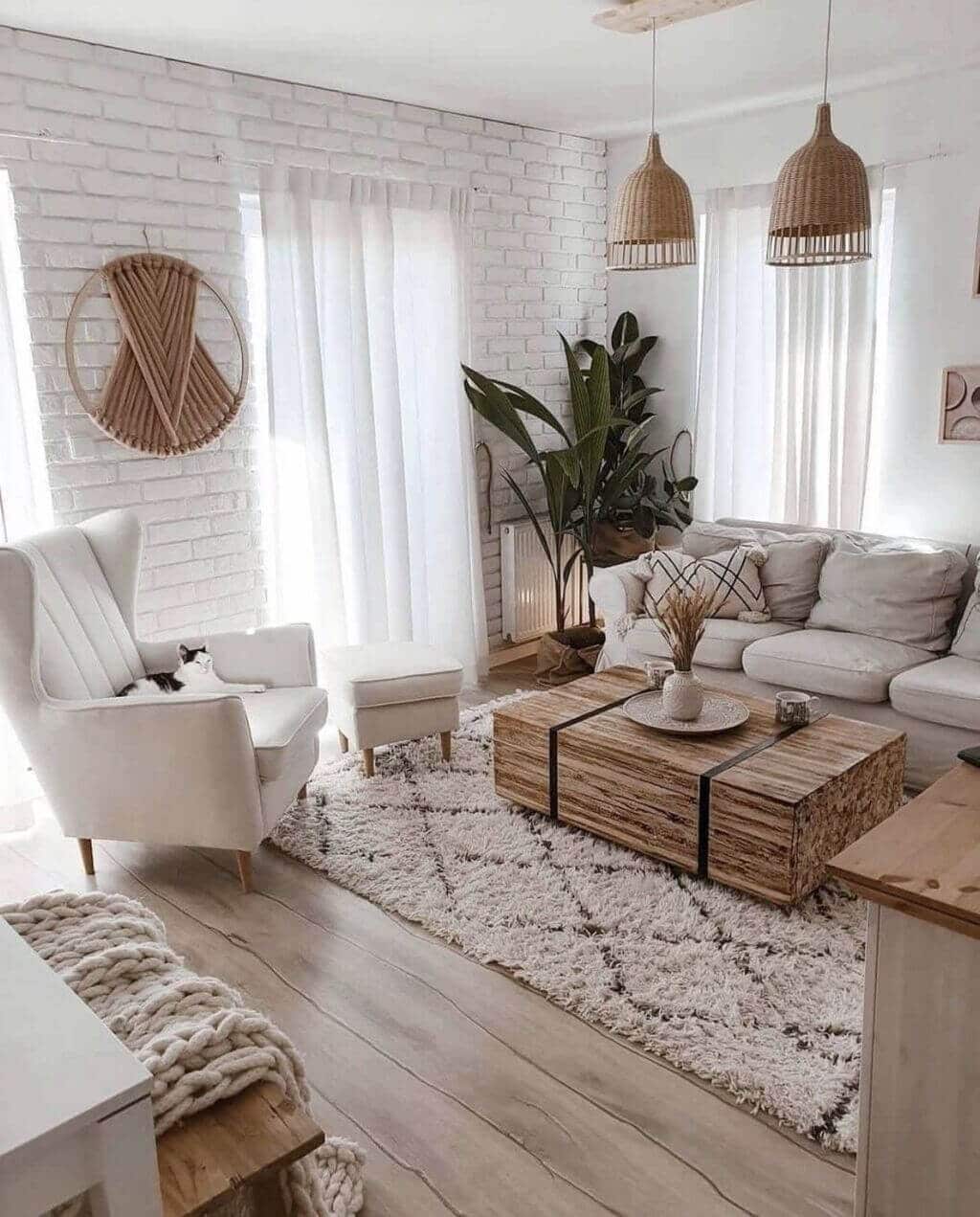 A living room filled with furniture and a white brick wall
