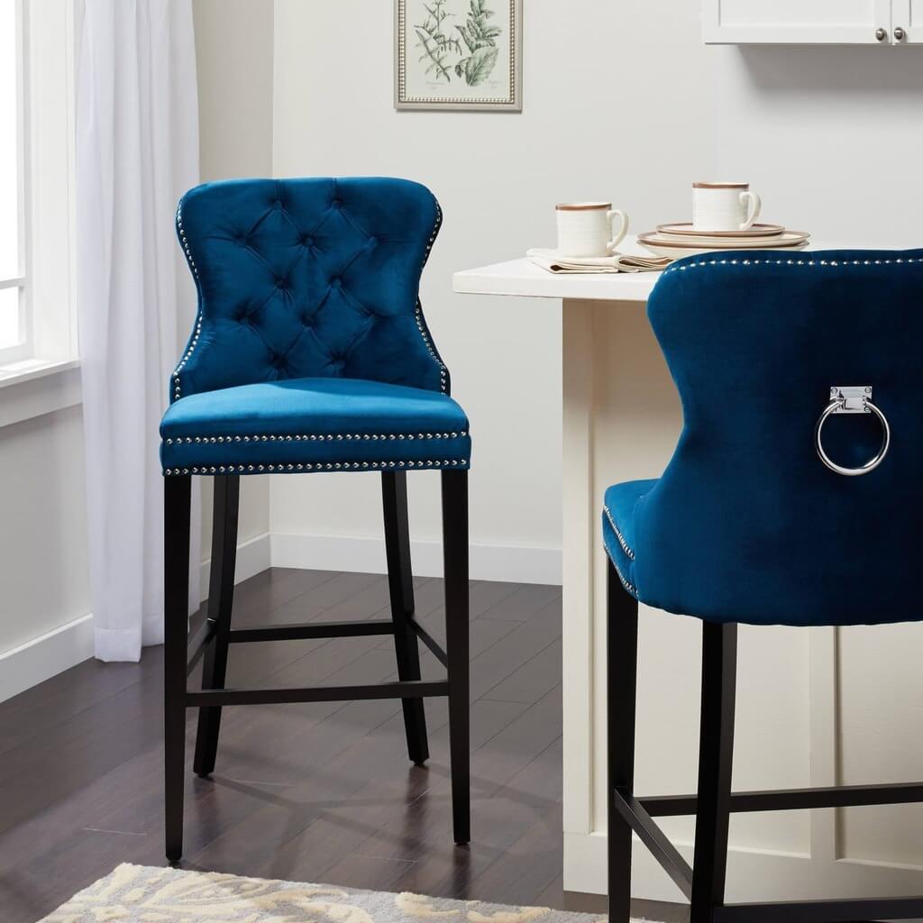 A pair of blue velvet bar stools in a kitchen
