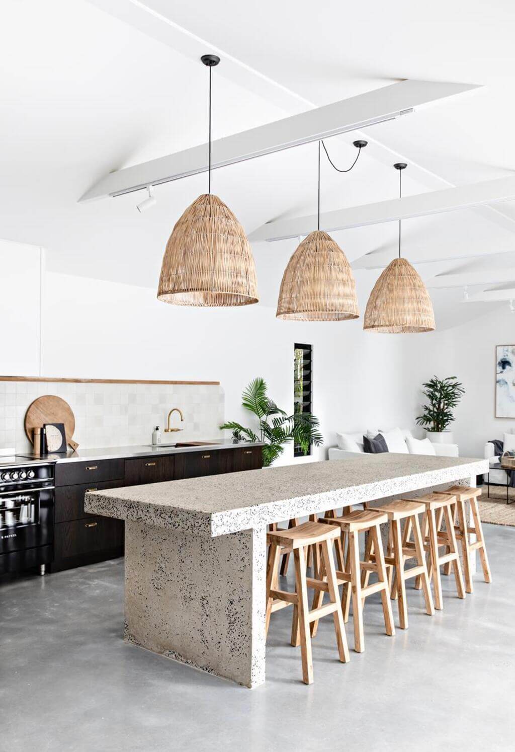 A kitchen with a counter and stools in it
