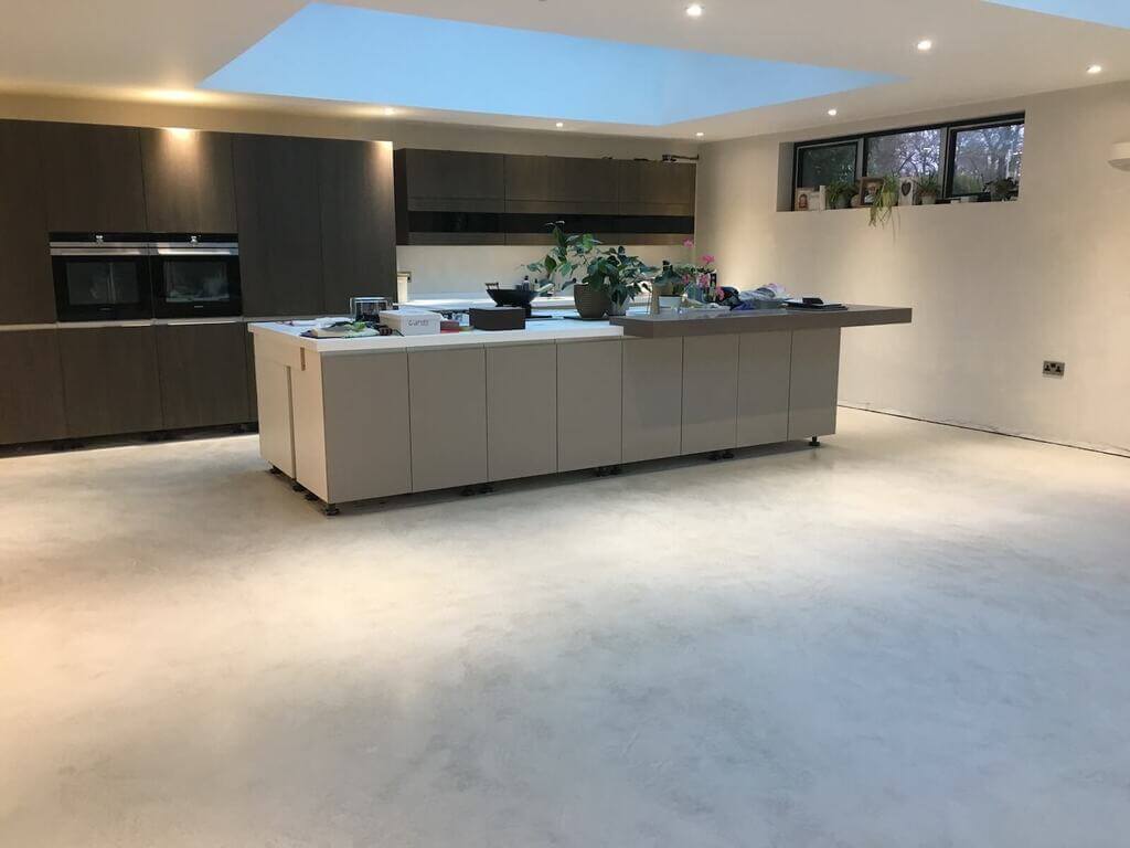 A large kitchen with a center island in the middle of the room
