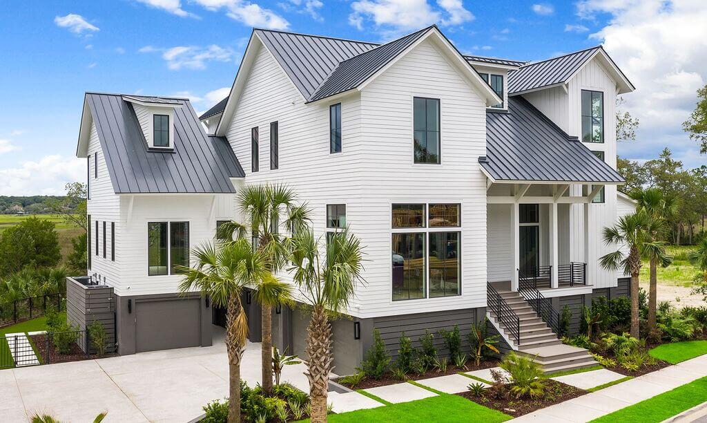 A large white house with a metal roof
