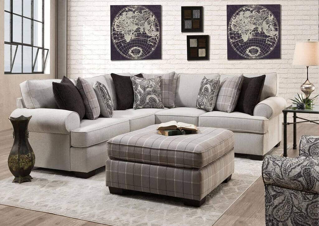 A living room with a sectional sofa and ottoman
