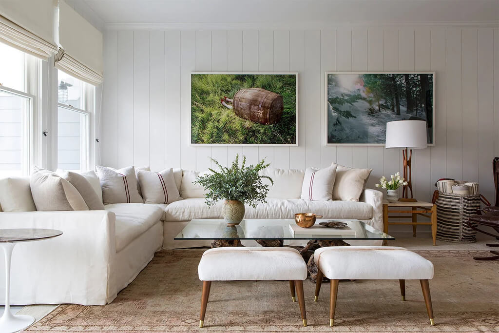 A living room filled with white sofa and a large window
